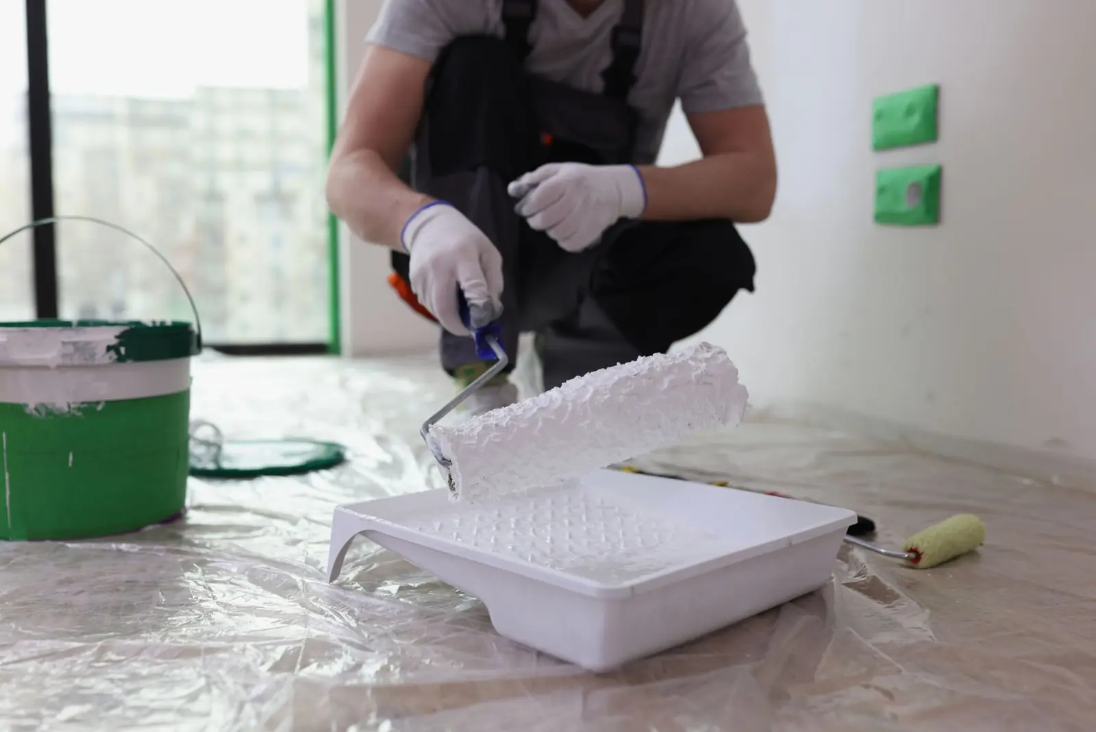 Painter rolling fresh paint inside a home
